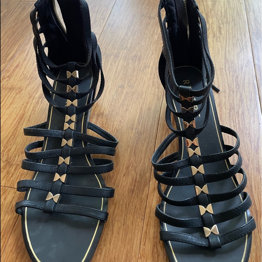 Report black w/gold accents shoes with zippers at heel.  Size 6.5. Nice heel!